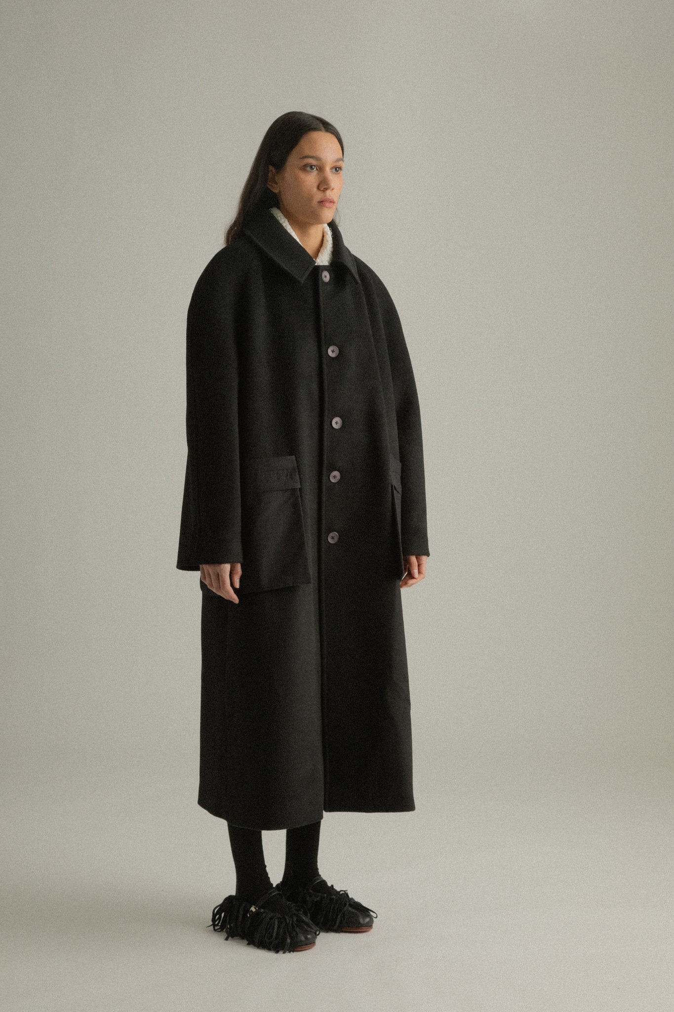  Alma Coat side view showing its relaxed fit and clean silhouette in superfine wool and organic cotton blend.