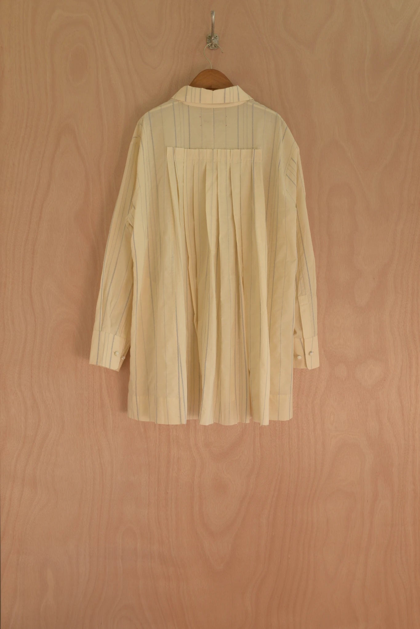 Back view of Assia Jacket showing pleat structure in custom woven fabric