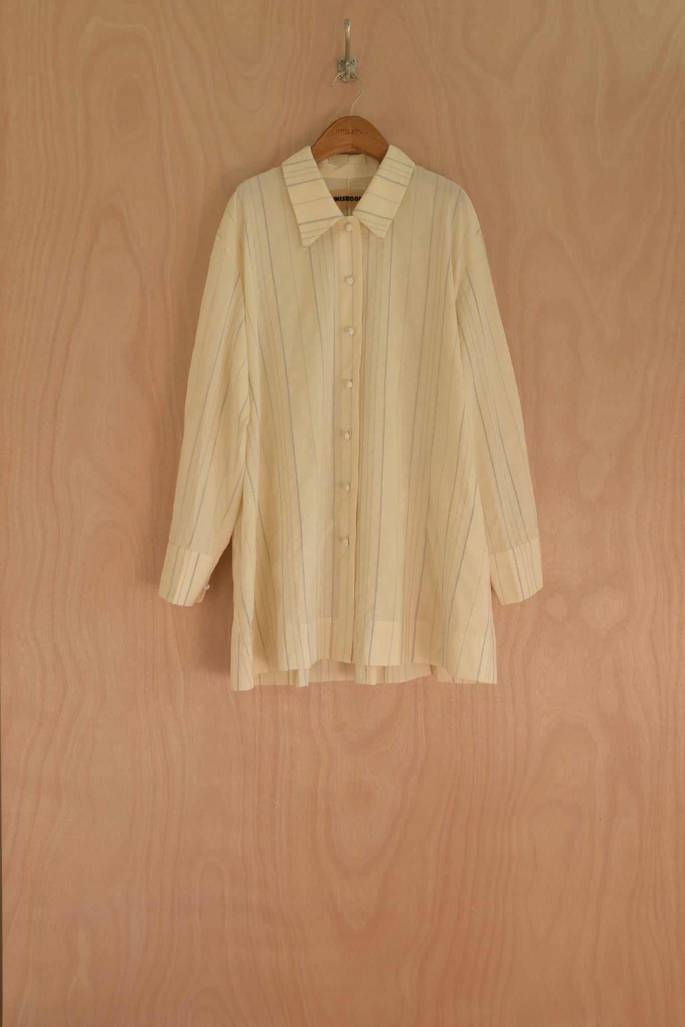 Front view of Assia Jacket in cream with hand-pressed blue thread, organic cotton