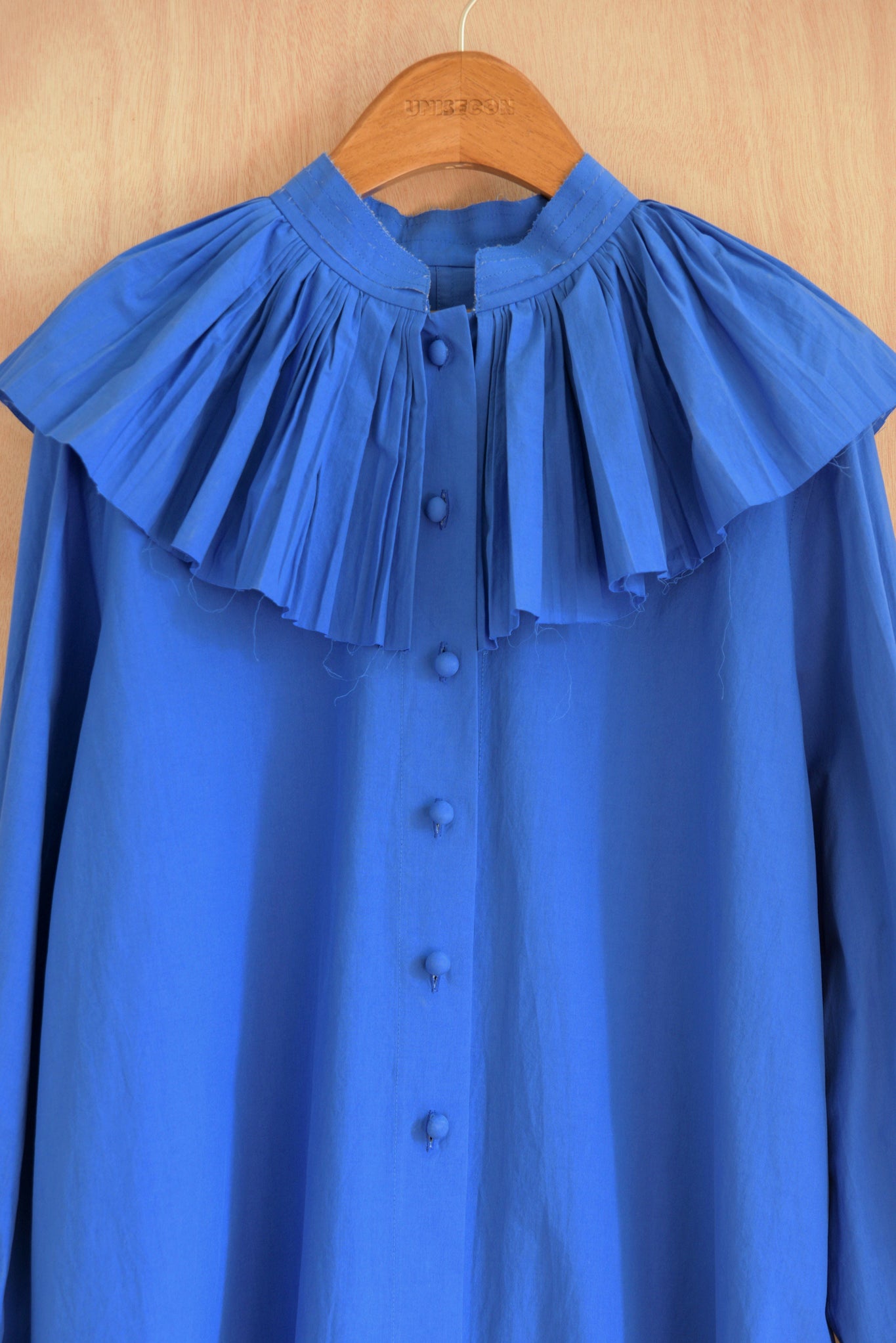 Intricate hand-pleated collar on Carcy Top in blue.