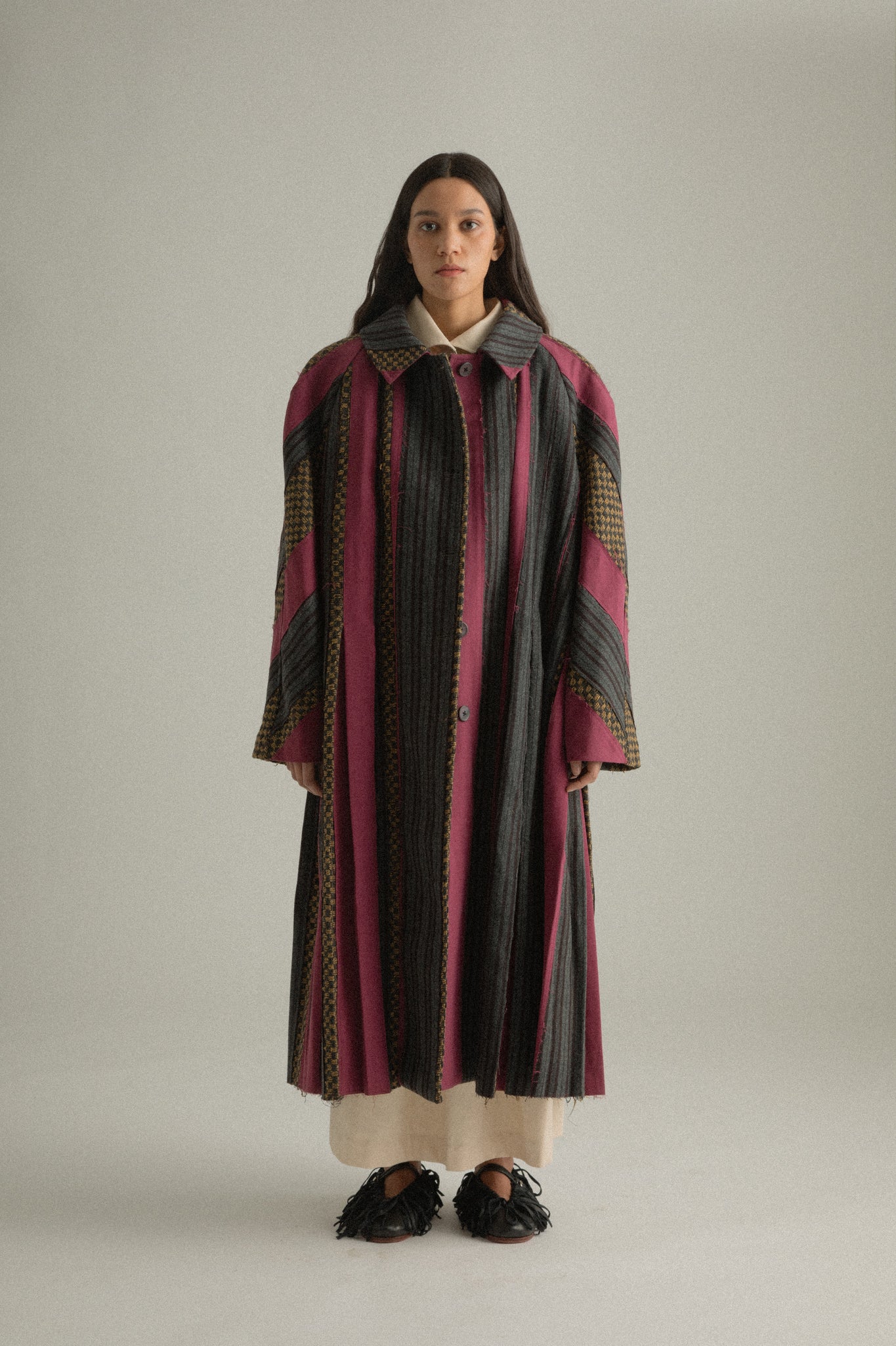 Front view of Emmeline Coat, full-length, showing patchwork detail and relaxed fit.