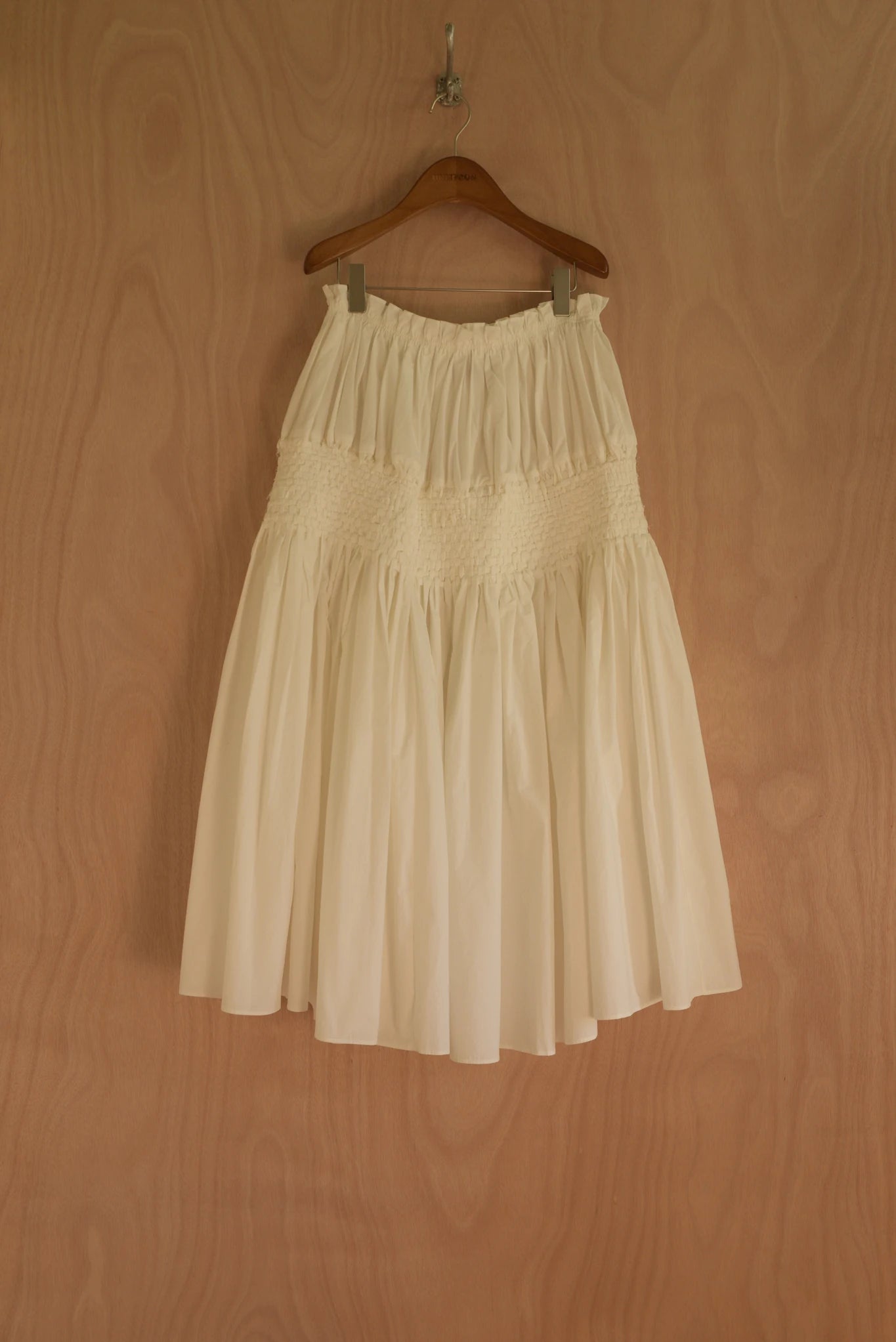 Front view of Joa Skirt in cream cotton with gathered structure and hand-woven center