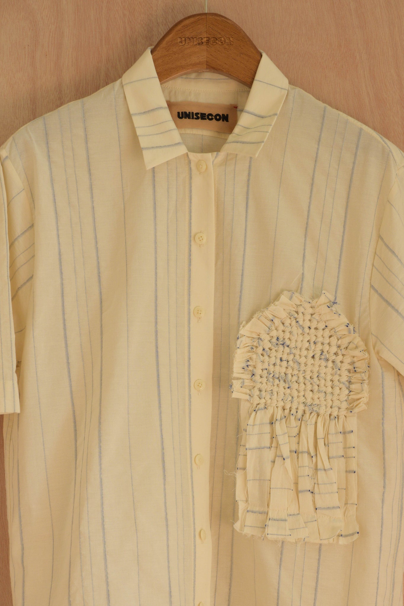 Close-up of hand-woven front patch and in-house striped fabric