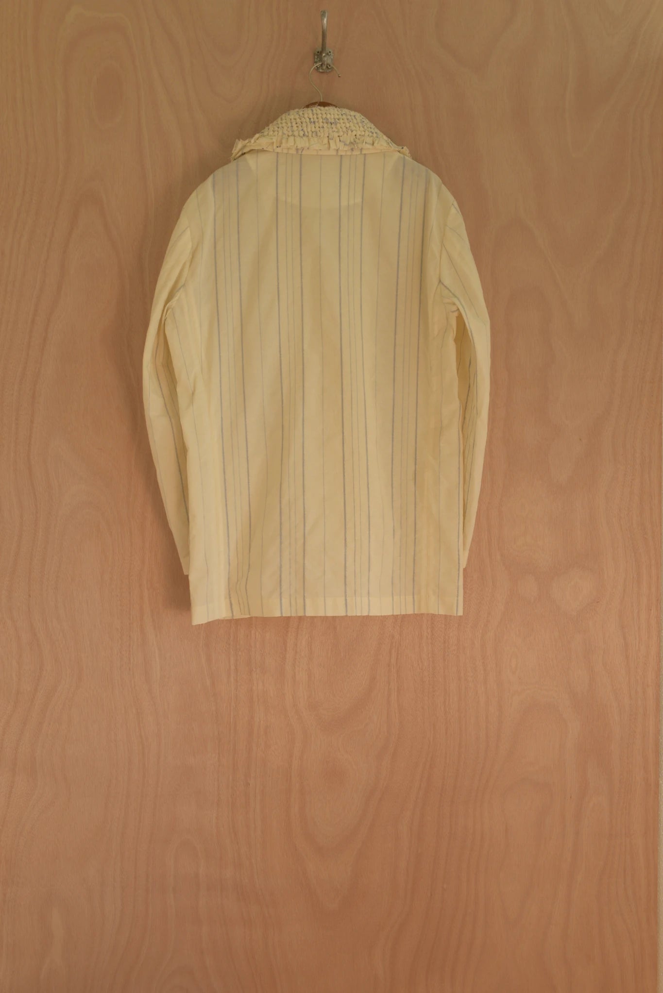 Back view showing relaxed cut and vertical woven stripes