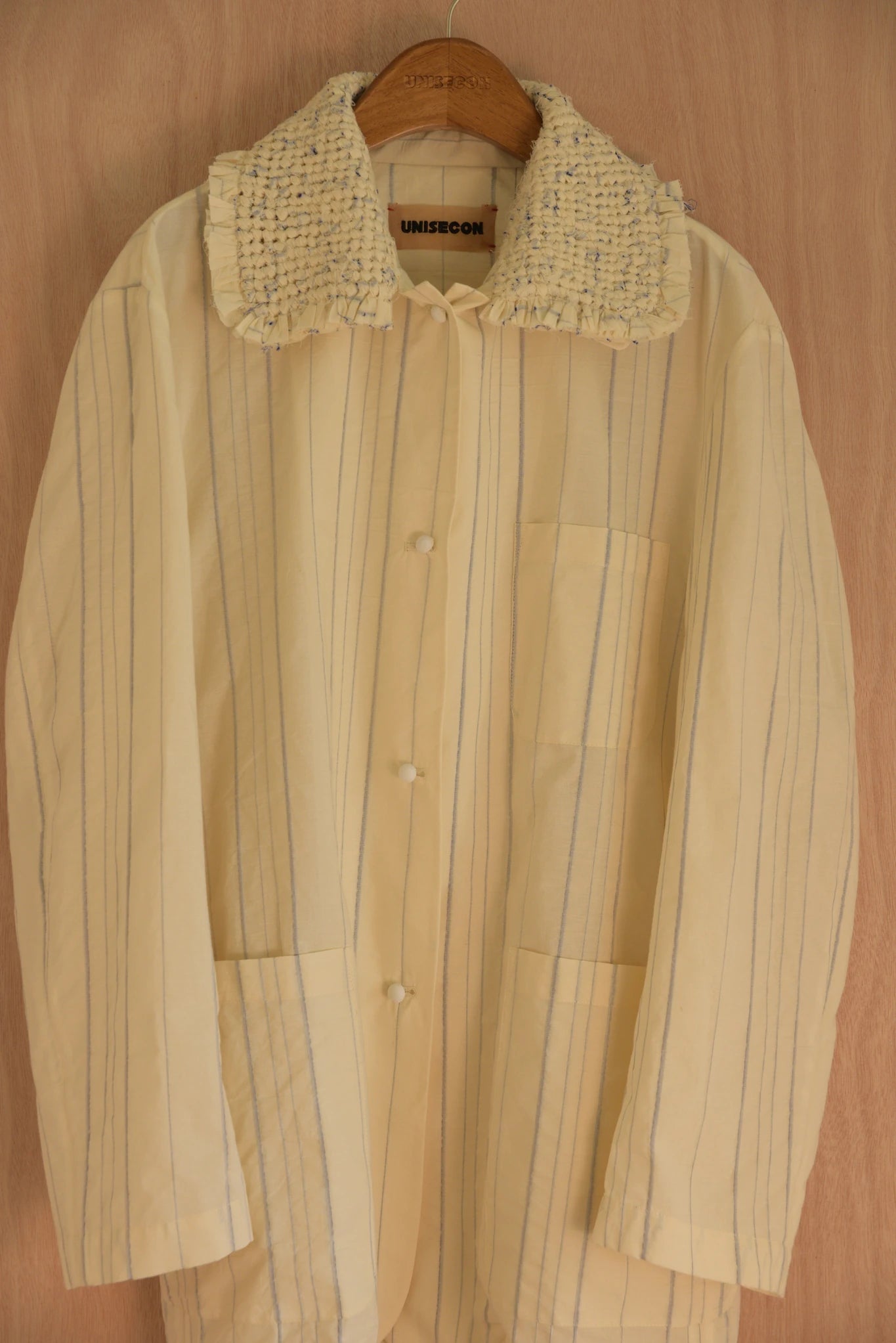 Detail of handmade collar and cotton-covered button