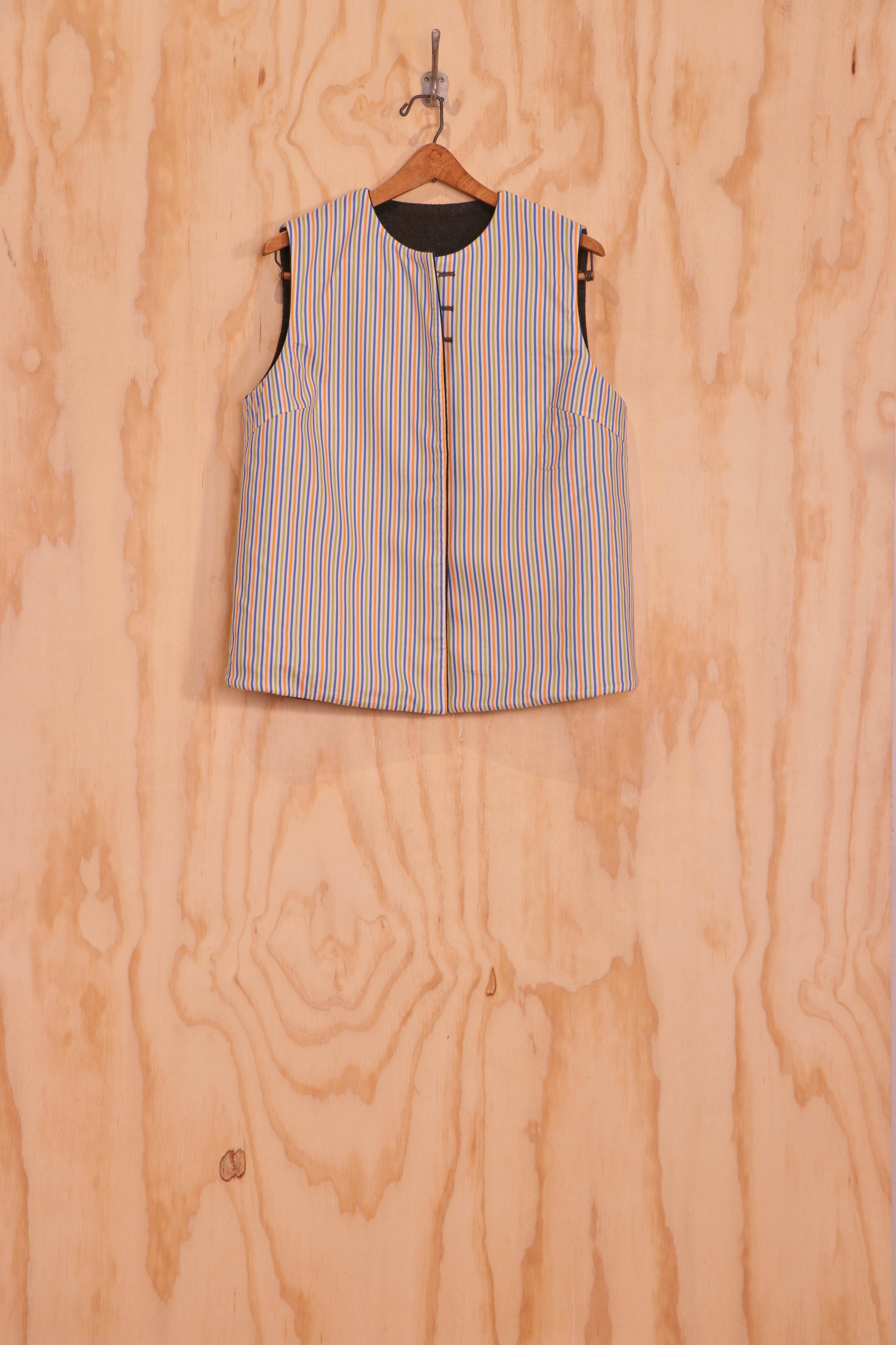 Front view of Mira Vest, striped organic-cotton face, three-button closure