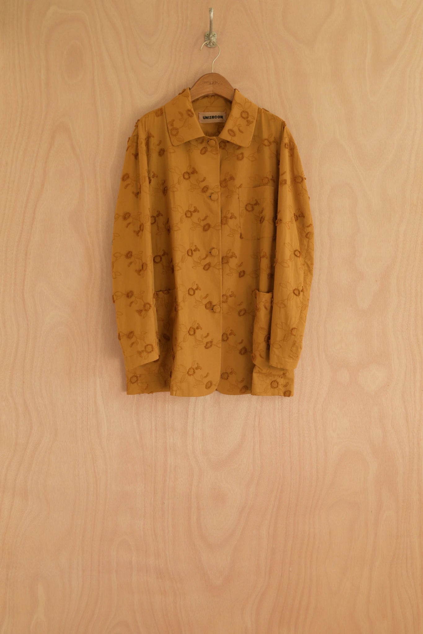 Front view of Nicole Jacket in turmeric cotton with tonal sunflower embroidery