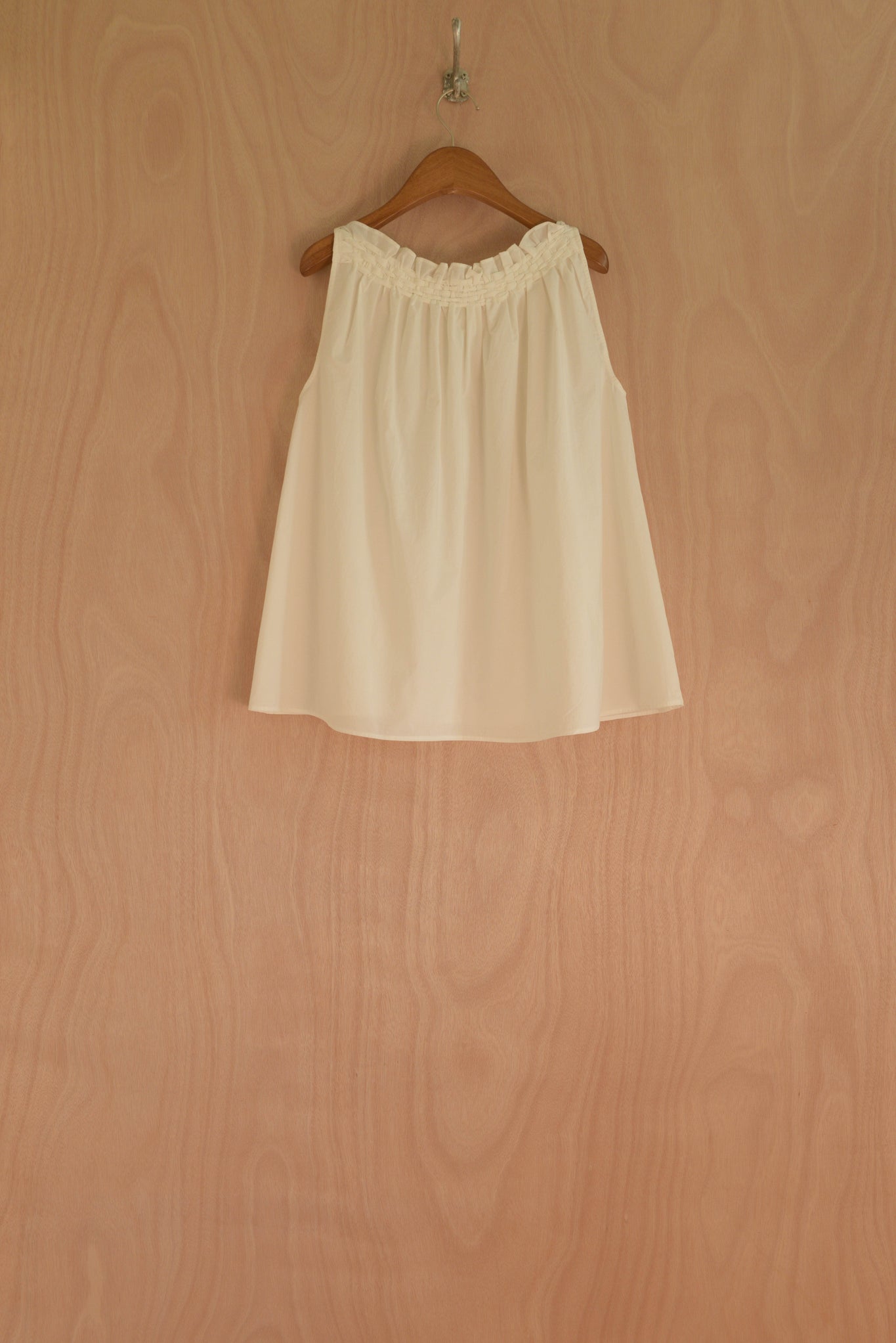 Back view of the Olga Top in white, highlighting the relaxed drape and airy fabric.