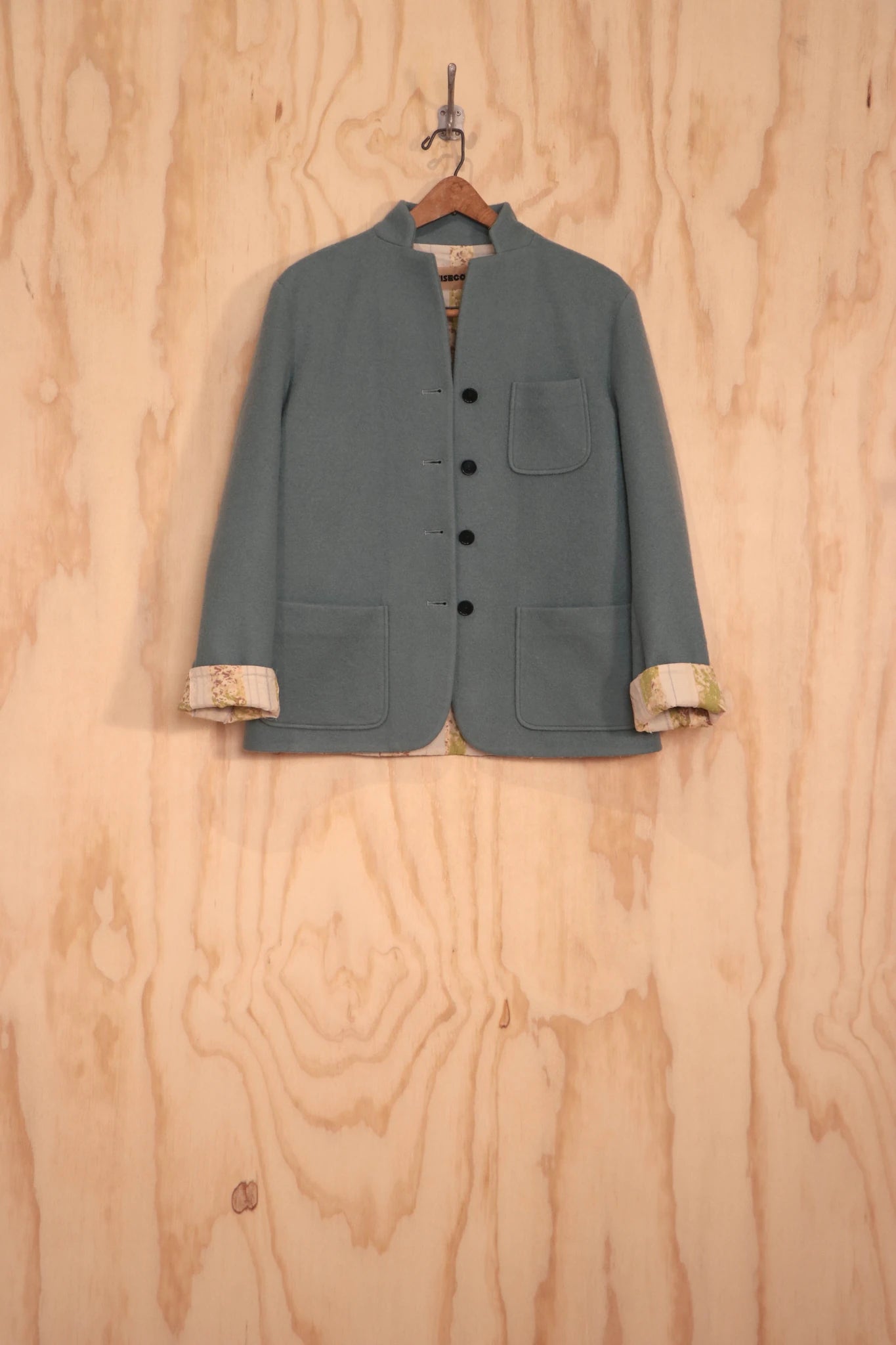 Close-up of collarless neckline and button placket