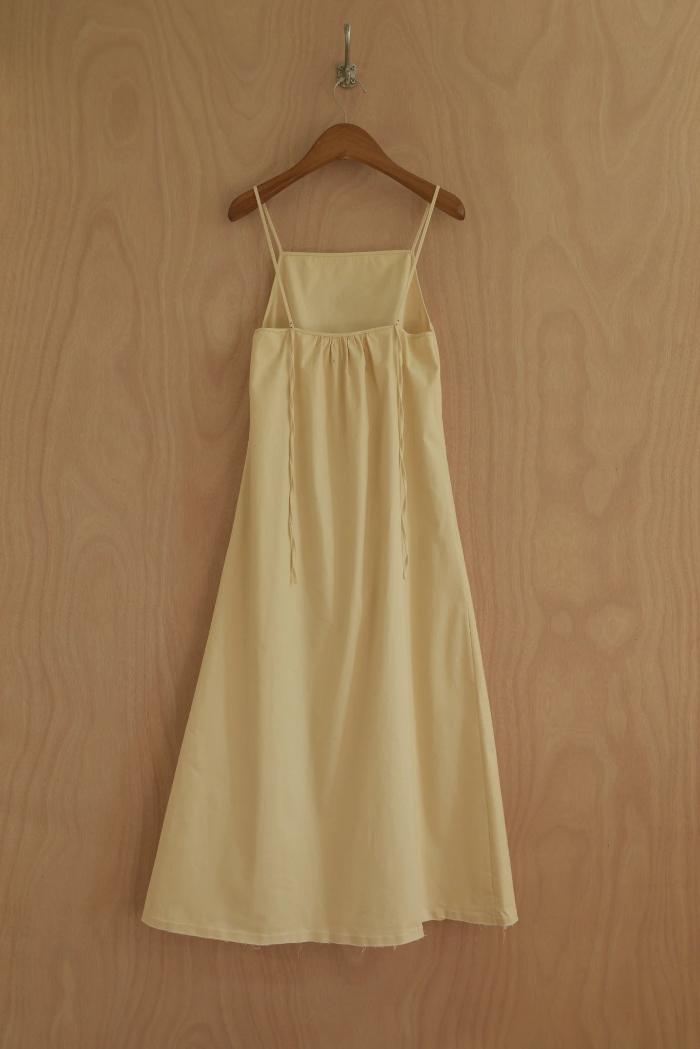 Back view of Paula Dress with clean drape and soft finish