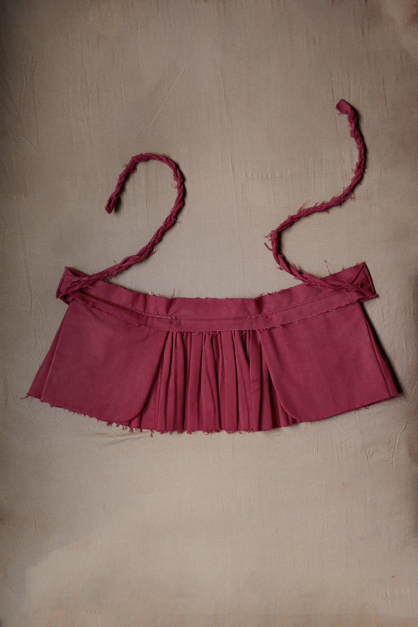 Purple Goma apron with fine pleats and raw edge details