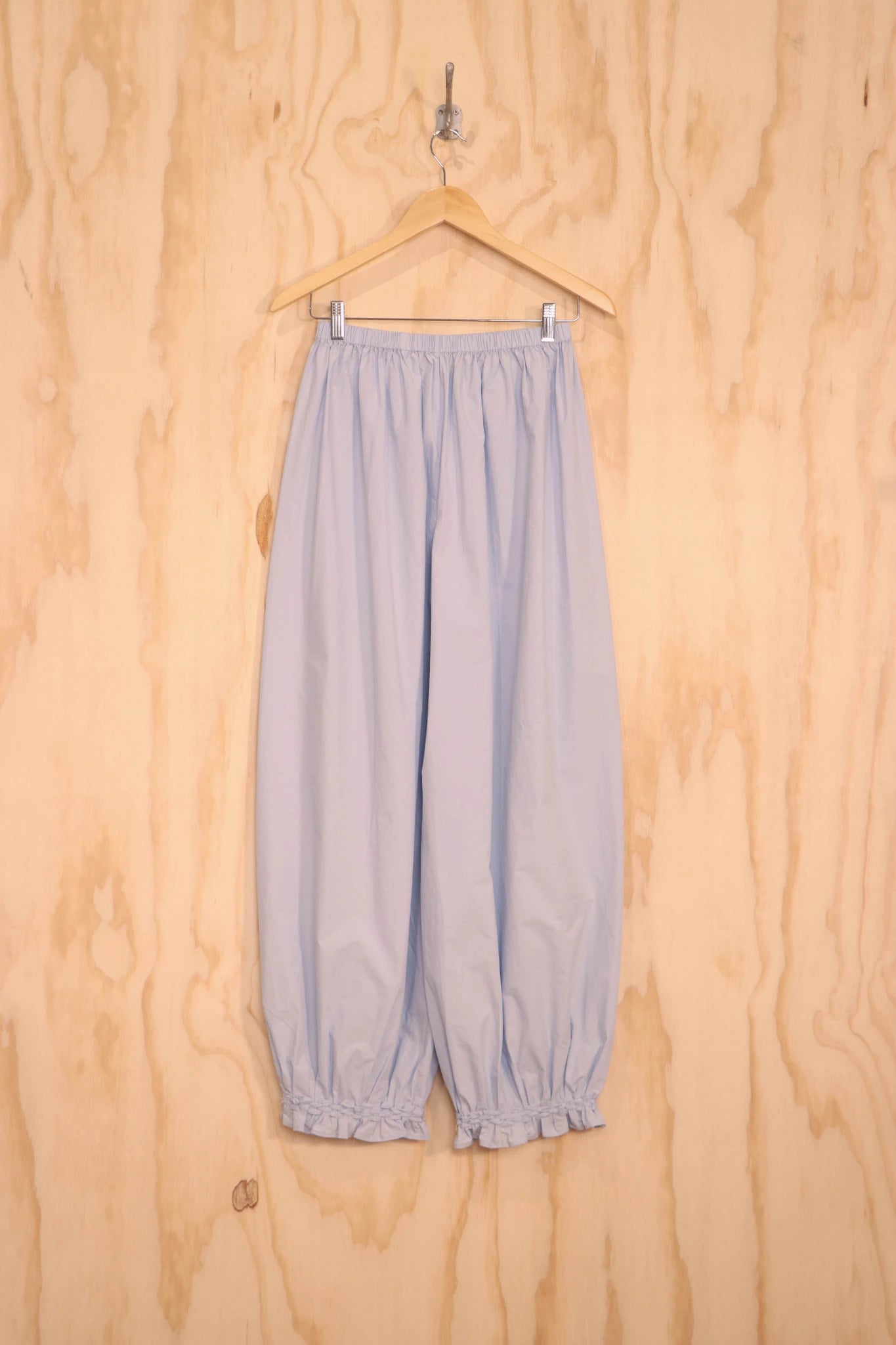 Back view showing relaxed volume and tapered gathered cuffs