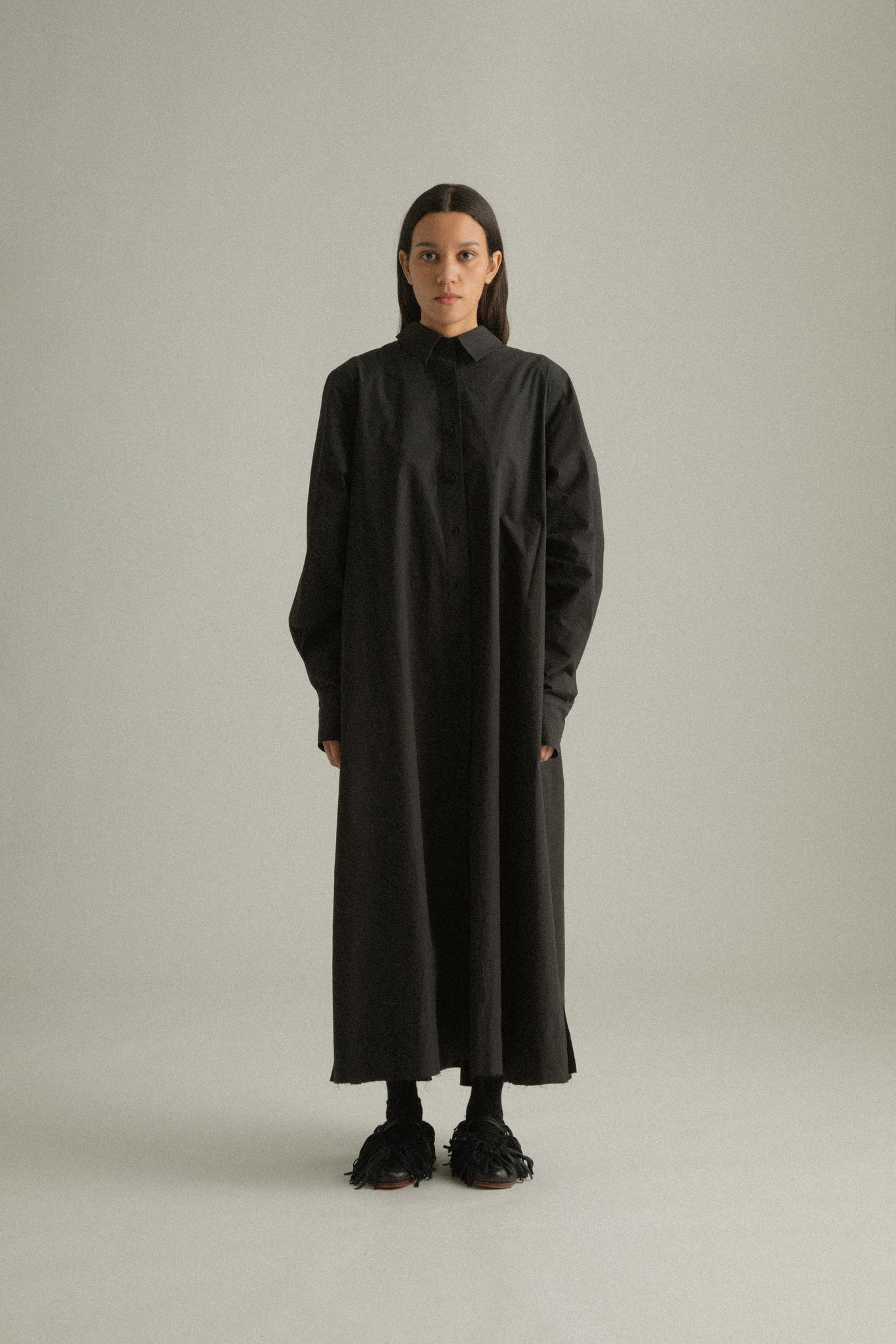 Full front view of Sylvie Coat in black organic cotton poplin, highlighting the button-front closure and relaxed fit.