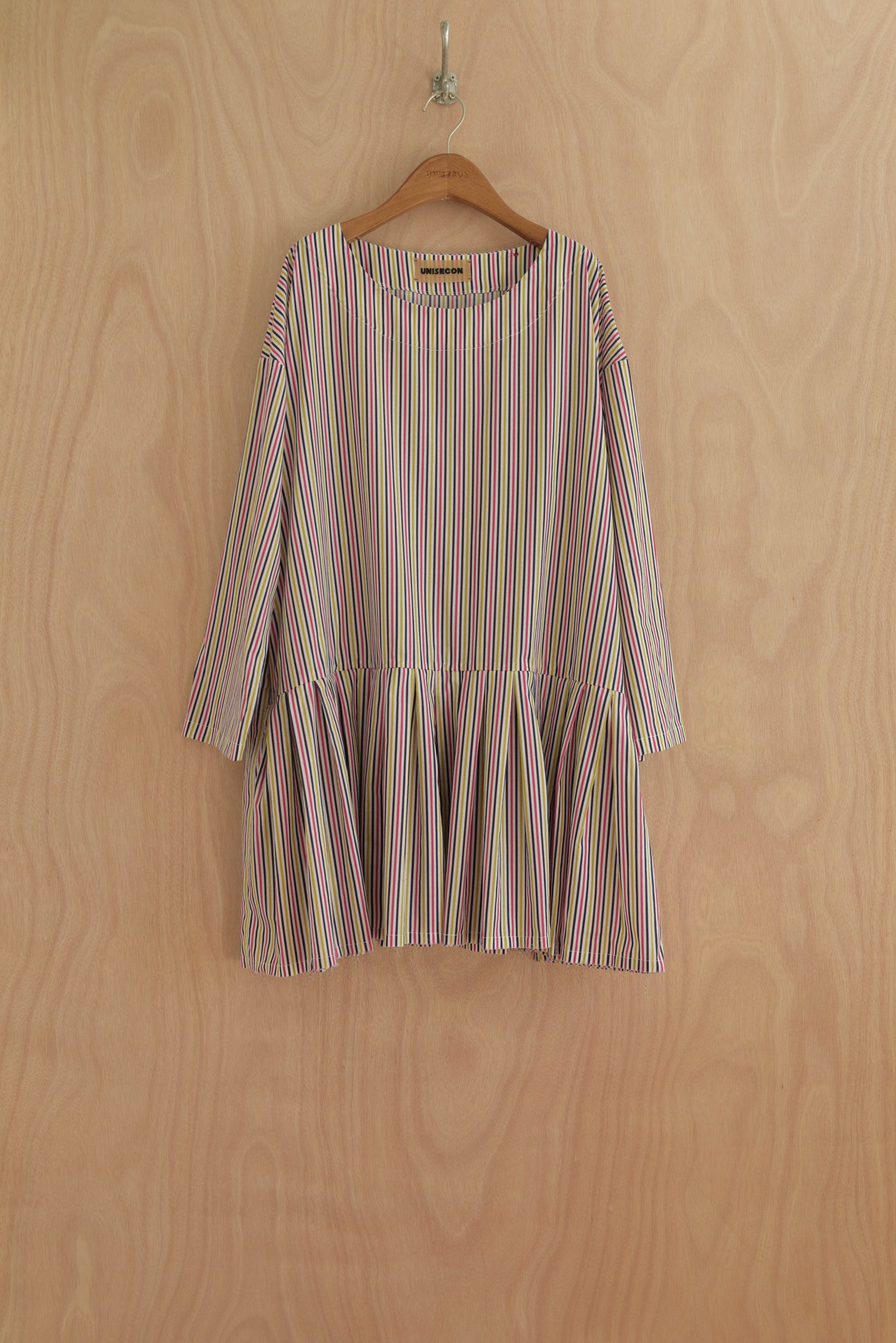 Front view of ULA top in multicolor cotton with gathered peplum
