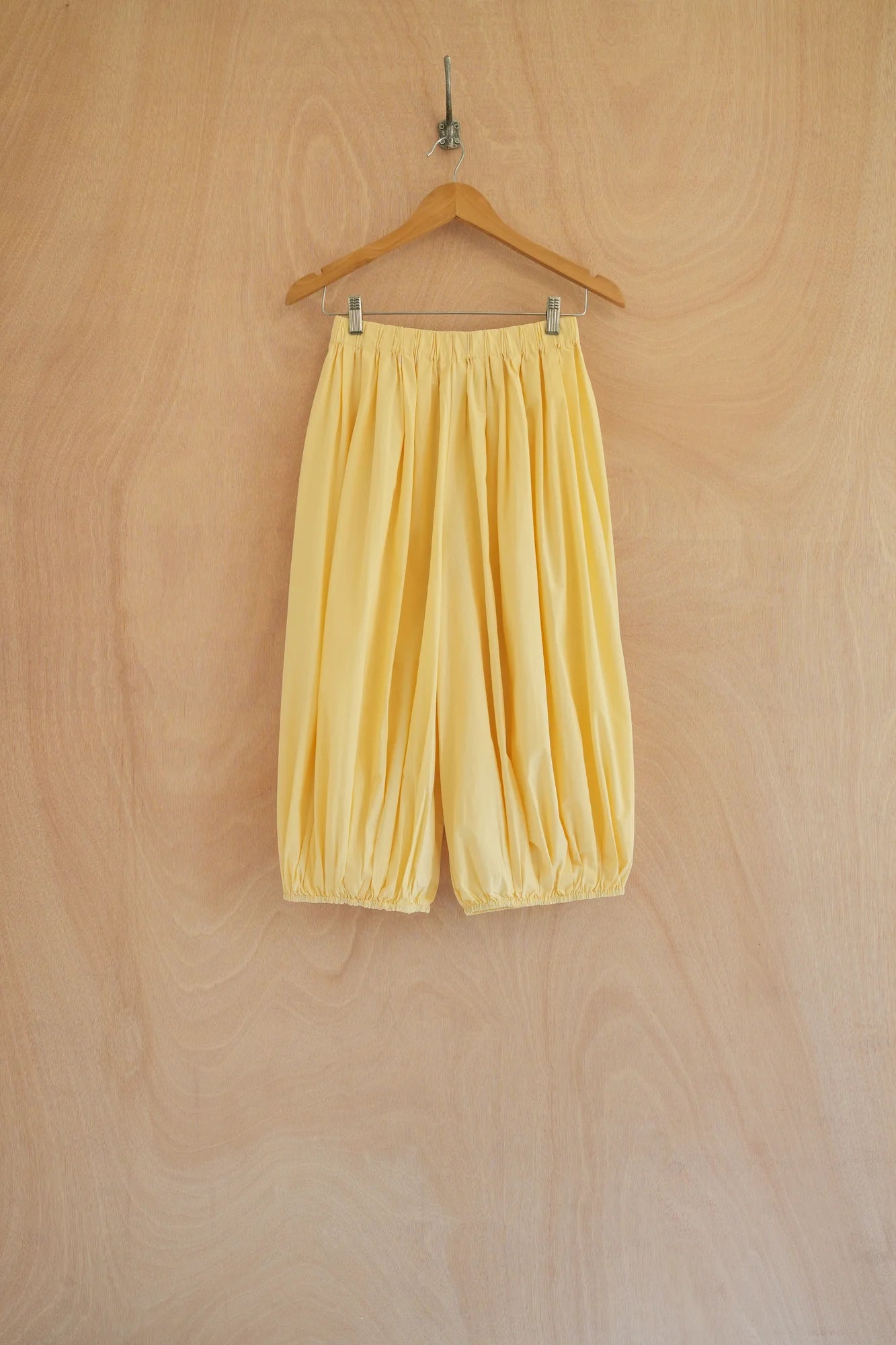 UNISECON Lume pants in yellow, front view