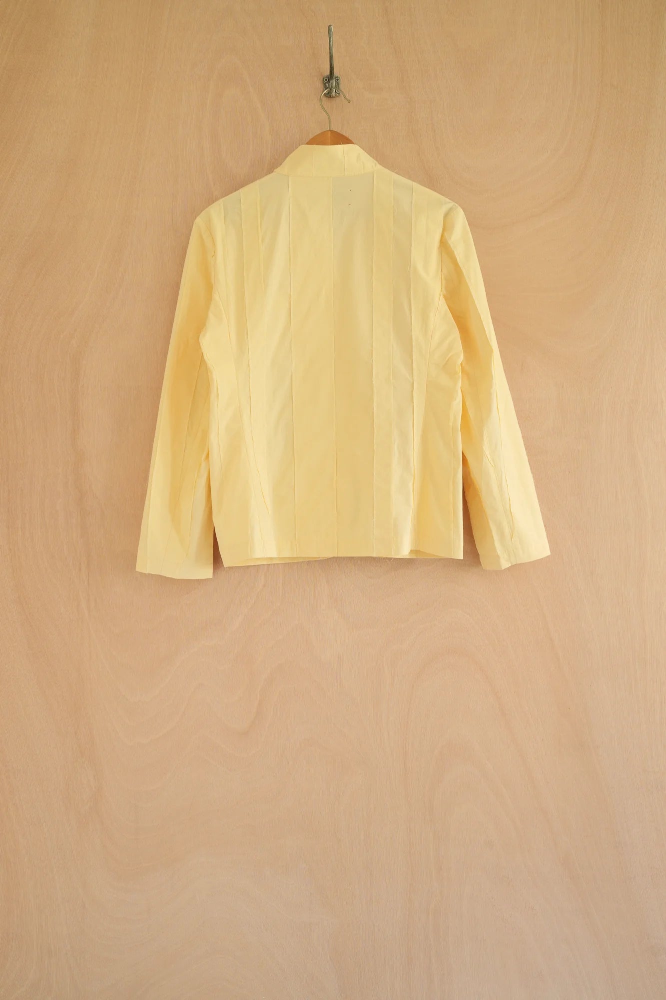UNISECON Patcha jacket in yellow, back view