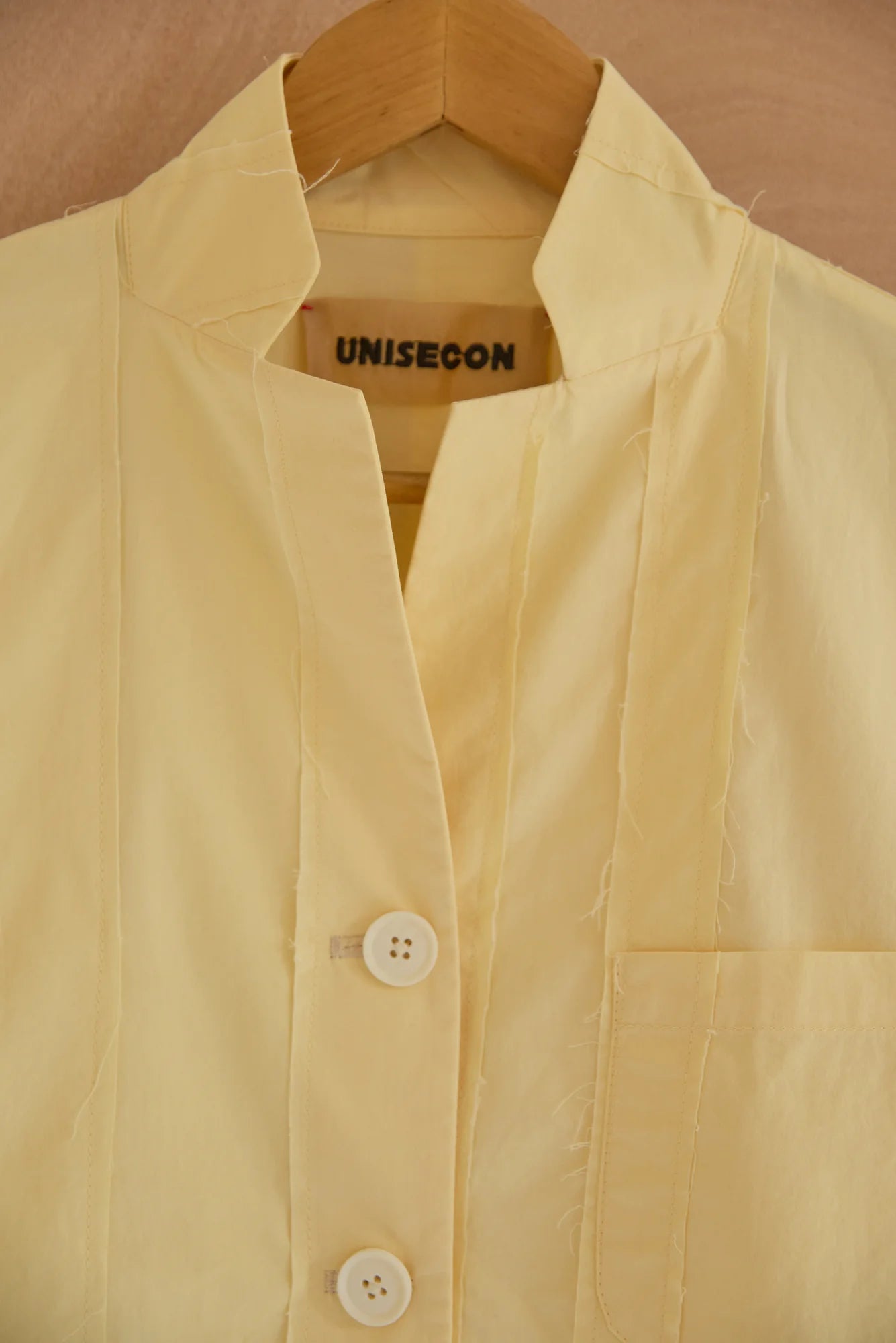 UNISECON Patcha jacket in yellow, detail view