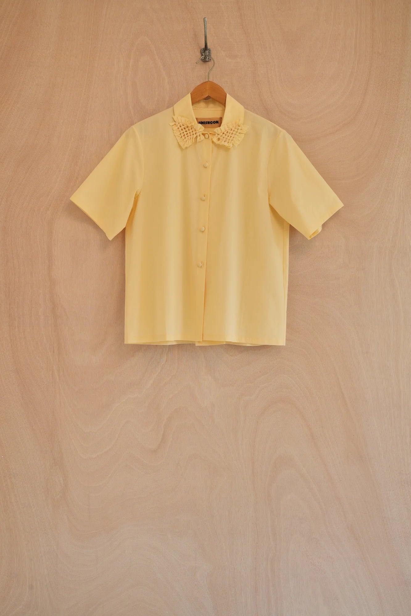 UNISECON Rui top in yellow, front view