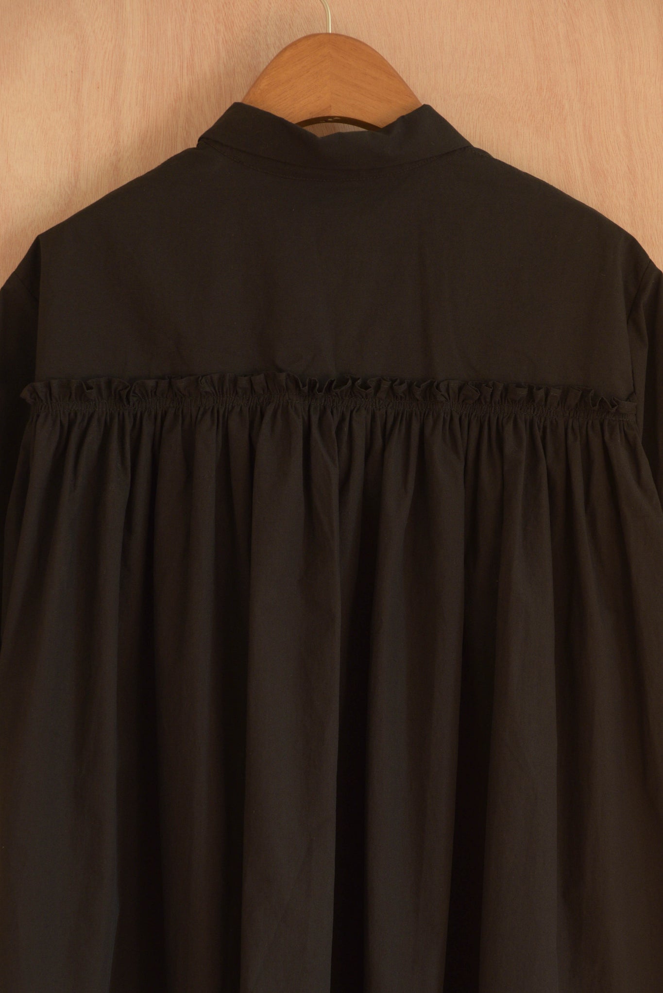 Intricate gathered pleats on the back of Wei Top in black.